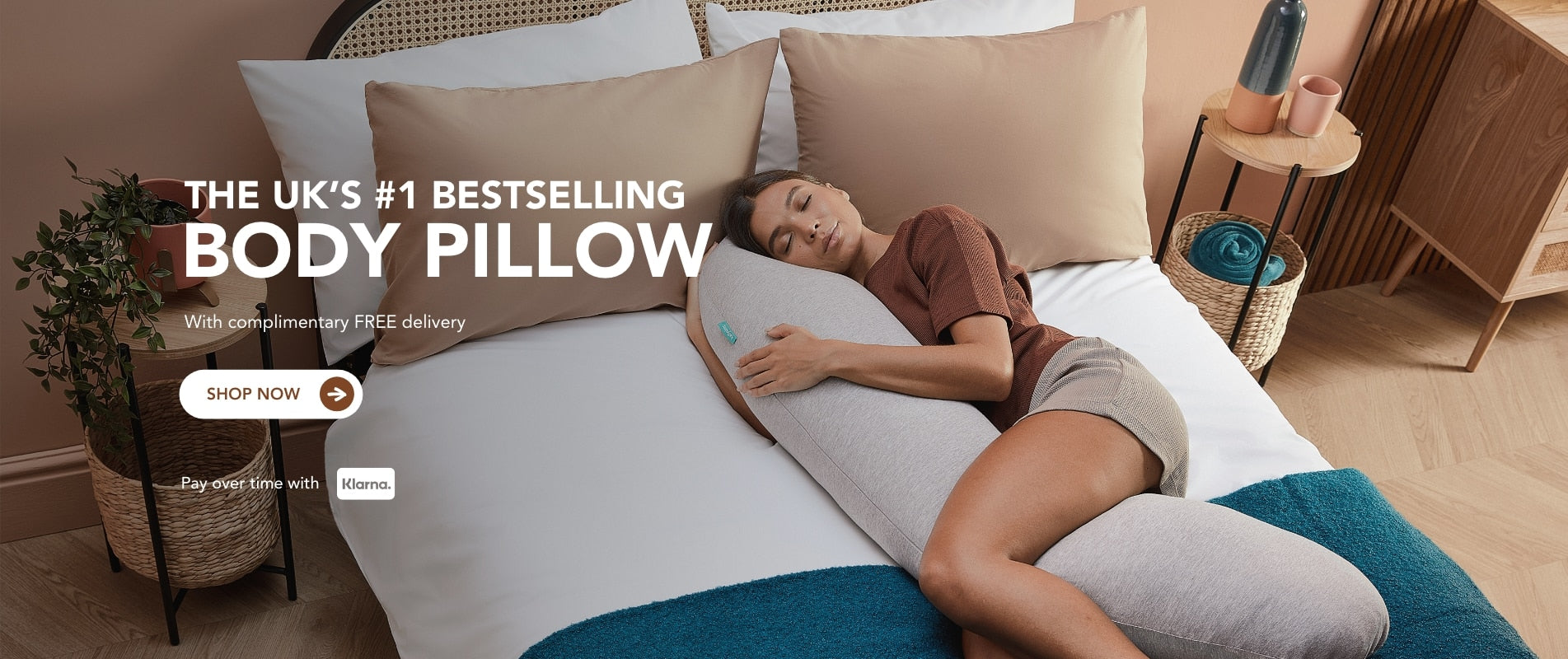Woman lying on a body pillow with text about it being the UK's #1 bestselling product.