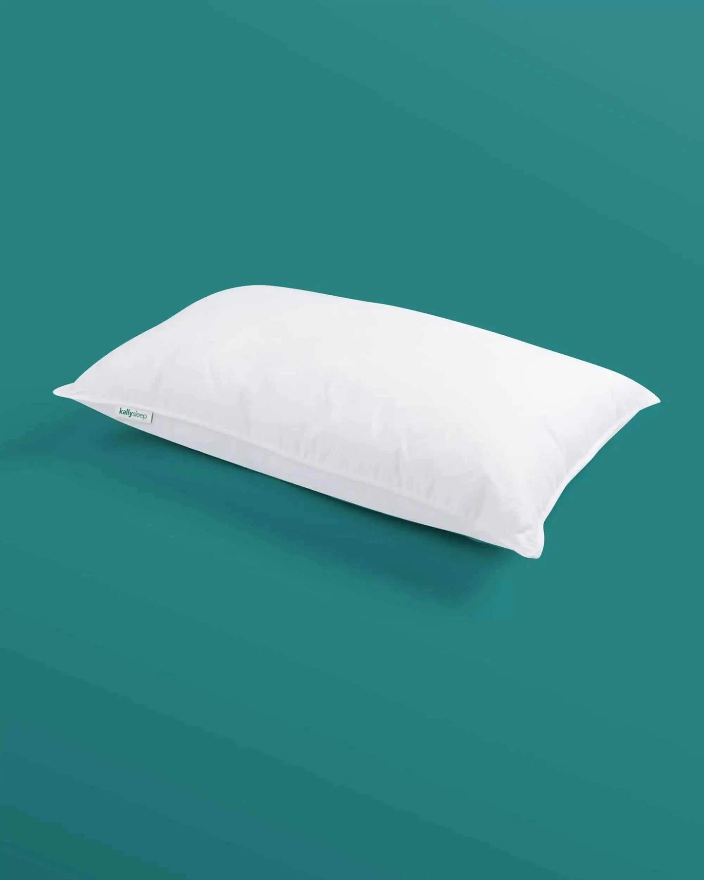 White ergonomic pillow on teal background, supportive sleep cushion for better posture