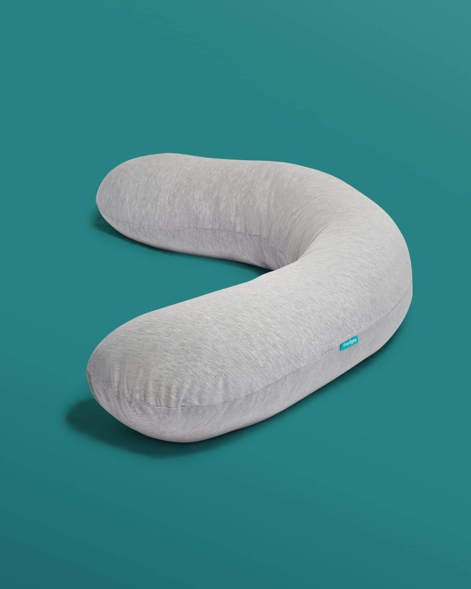Gray body pillow on a teal background