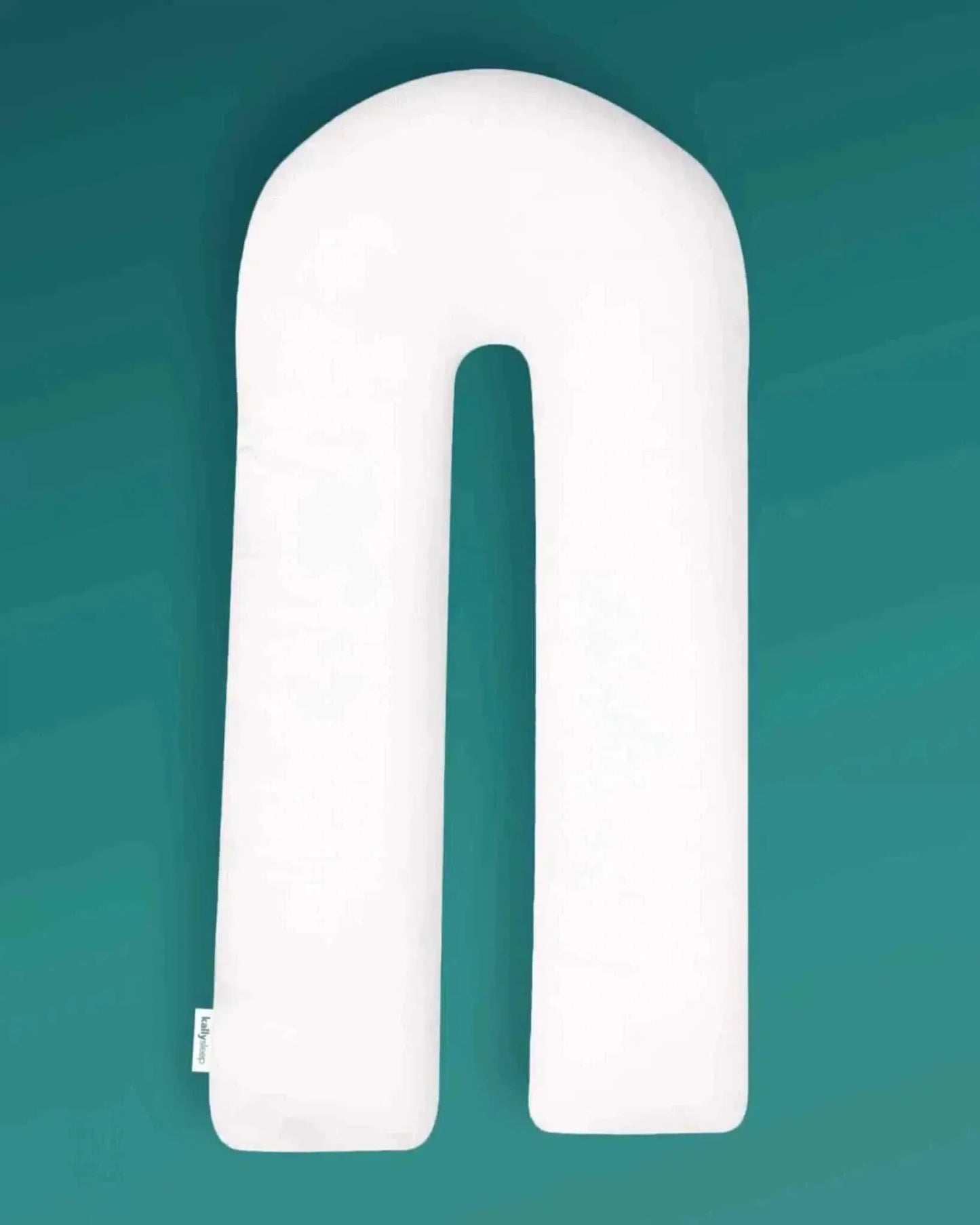U-shaped ergonomic white body pillow on teal background for posture support and sleep
