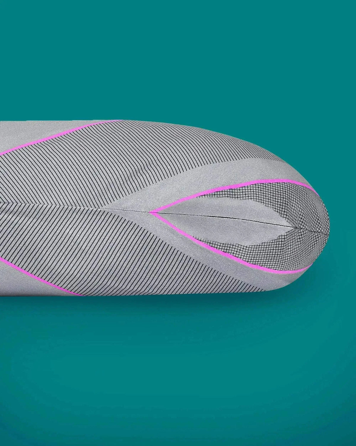 Close-up of a Kallysleep Sports Recovery Pillowcase with gray patterned fabric and pink piping.