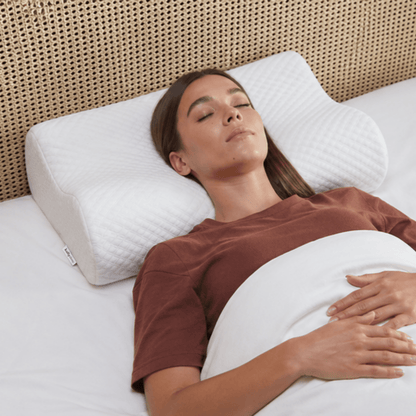 Woman sleeping on a white pillow with a brown shirt